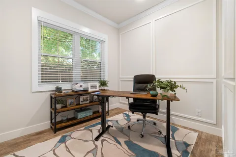 a view of a workspace with furniture and a window