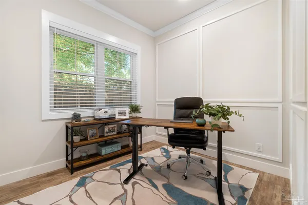 a view of a workspace with furniture and a window