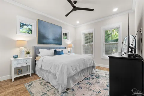 a bedroom with a bed and a flat tv screen on dresser