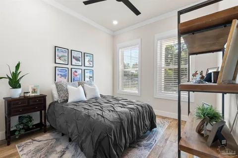 a bedroom with a large bed and a potted plant