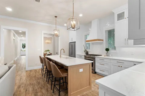 a kitchen with a table chairs sink and cabinets
