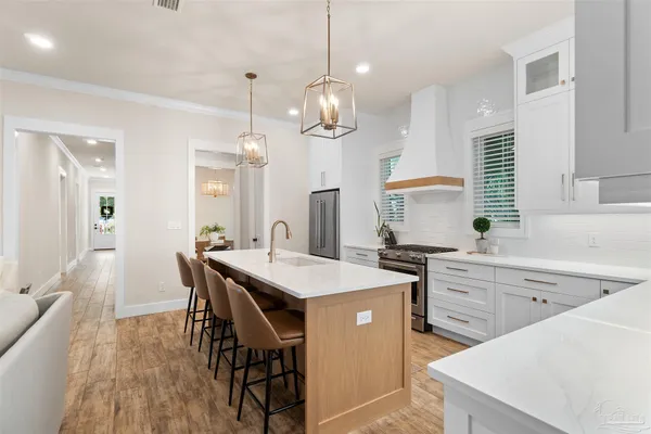 a kitchen with a table chairs sink and cabinets