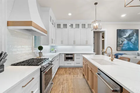 a kitchen with a sink stove and cabinets