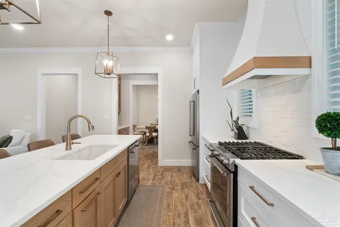 a kitchen with stainless steel appliances a sink stove and refrigerator