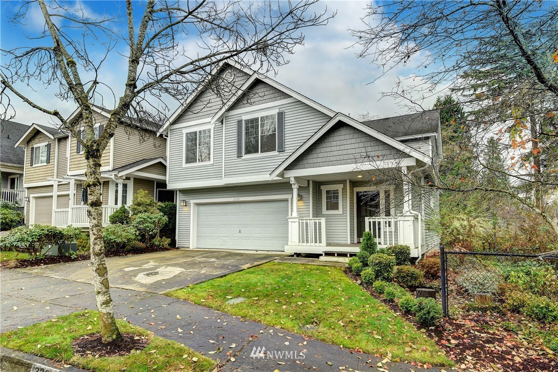 2324 194th Street Southeast Bothell, WA 98012 - Photo 1 of 22 a view of a white house next to a yard with potted plants