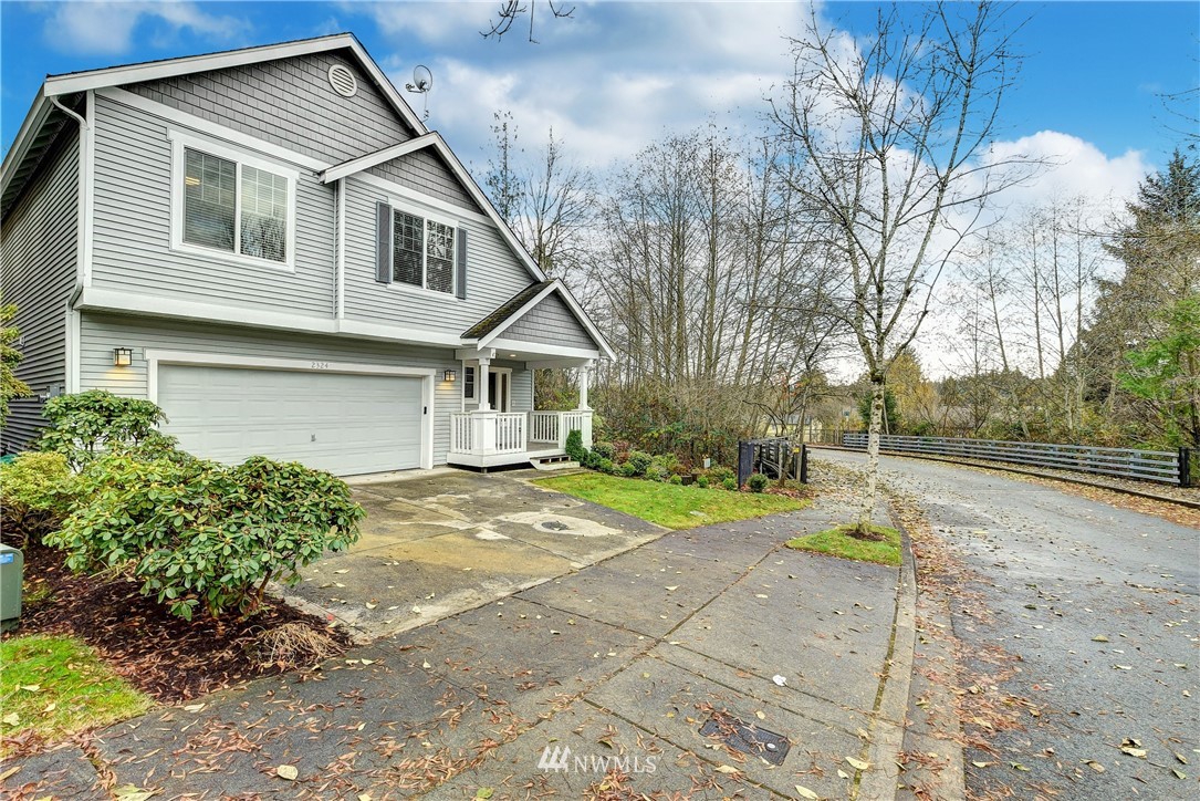 2324 194th Street Southeast Bothell, WA 98012 - Photo 2 of 22 a front view of a house with a yard and garage