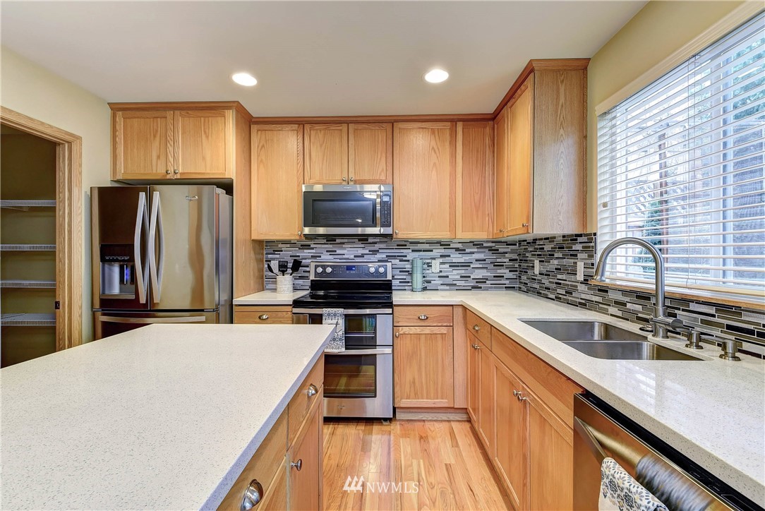 2324 194th Street Southeast Bothell, WA 98012 - Photo 11 of 22 a kitchen with stainless steel appliances a refrigerator sink and cabinets