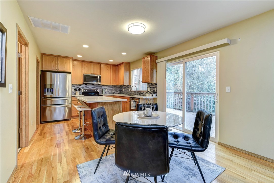 2324 194th Street Southeast Bothell, WA 98012 - Photo 12 of 22 a kitchen with a table chairs refrigerator and cabinets