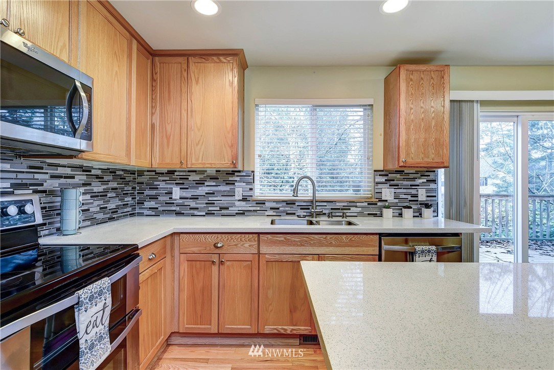 2324 194th Street Southeast Bothell, WA 98012 - Photo 10 of 22 a kitchen with stainless steel appliances granite countertop a stove a sink and a microwave