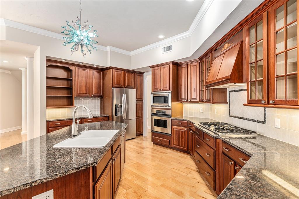 10614 Southwest 15th Lane Gainesville, FL 32607 - Photo 21 of 85 a kitchen with stainless steel appliances granite countertop a sink stove and refrigerator