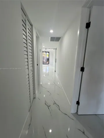 a view of empty room with sliding door