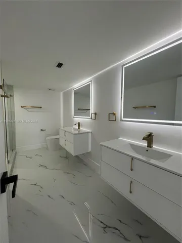 a utility room with cabinets washer and dryer