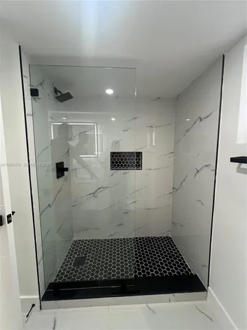 a view of a house with a big yard and wooden fence