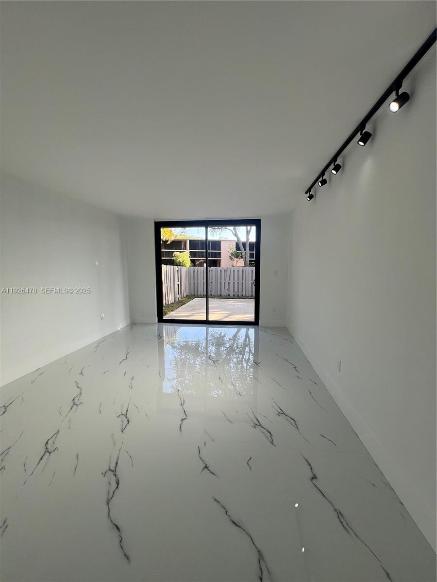 20610 Northeast 7th Court Miami, FL 33179 - Photo 23 of 38 a view of empty room with sliding door