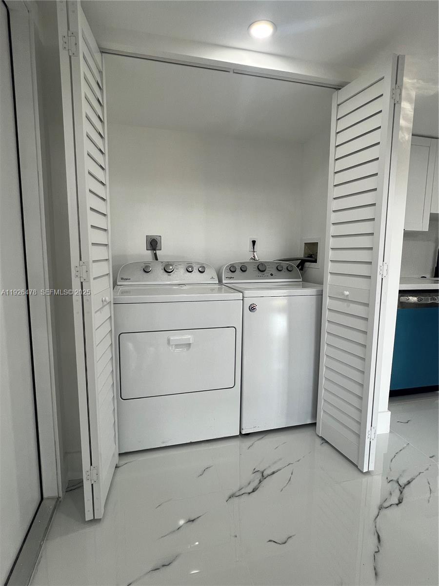 20610 Northeast 7th Court Miami, FL 33179 - Photo 29 of 38 a utility room with cabinets washer and dryer