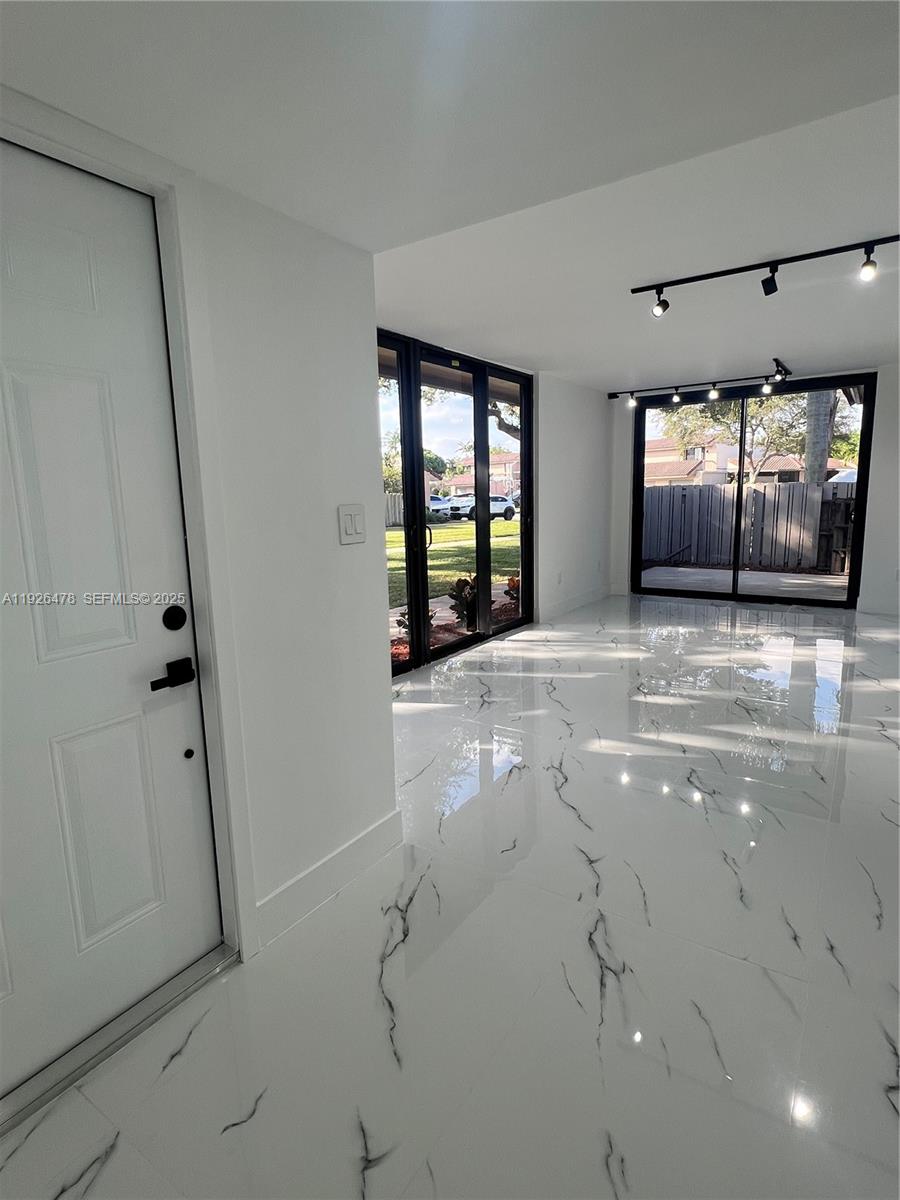 20610 Northeast 7th Court Miami, FL 33179 - Photo 8 of 38 a view of room with window and stairs