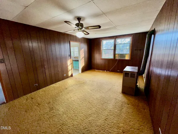 a view of an empty room with a fireplace