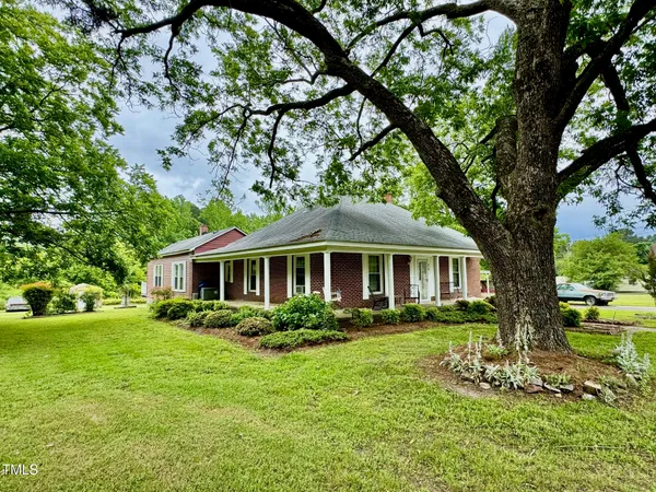 a front view of house with yard and green space