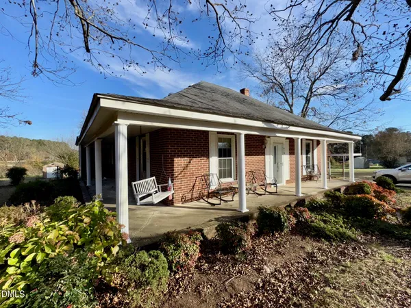 a front view of a house with a sitting area