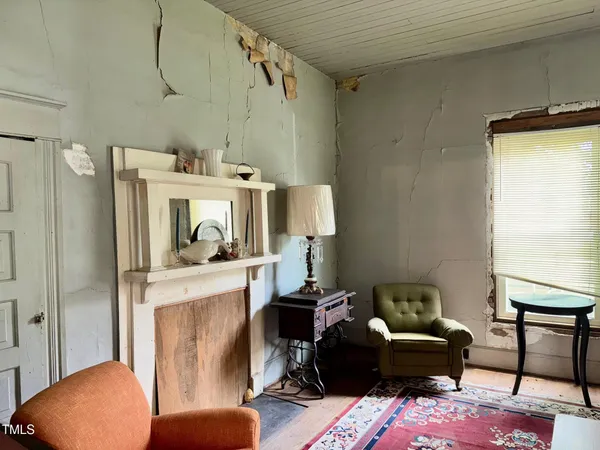 a bed sitting in a spacious bedroom next to a window