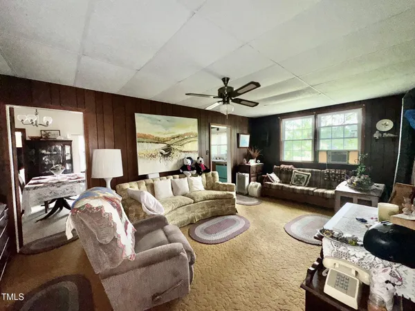 a bed sitting in a spacious bedroom next to a window
