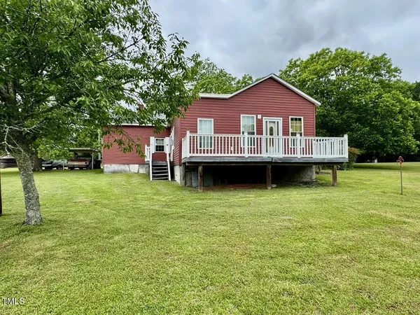 a view of a house with a garden and deck