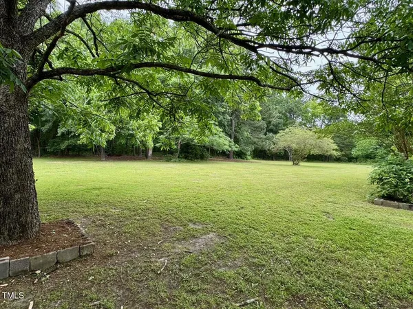 a view of an empty room with a fireplace
