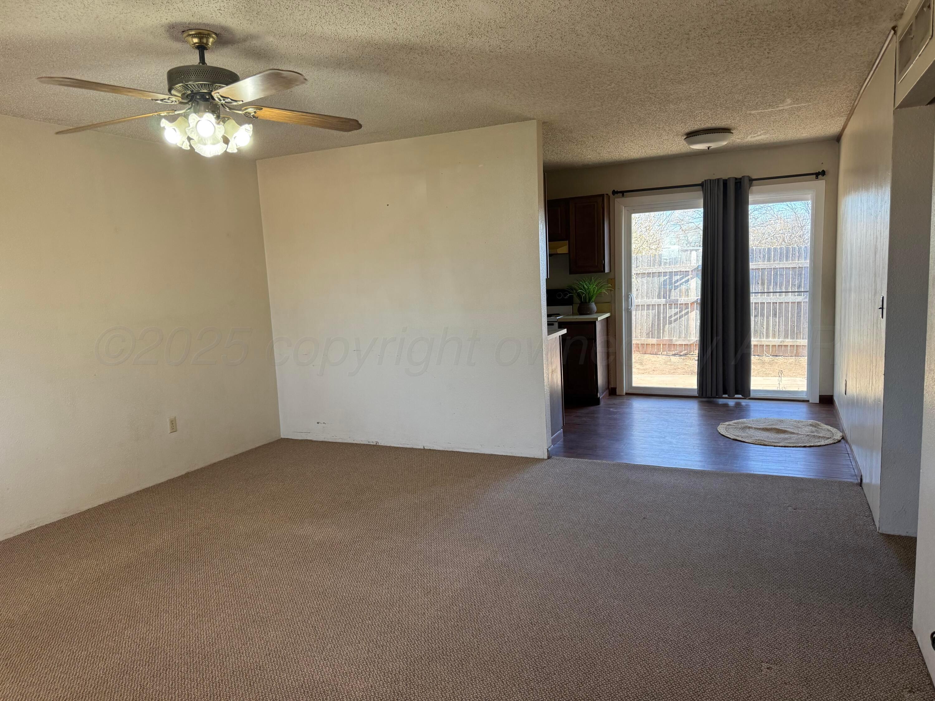 403 3rd Avenue Canyon, TX 79015 - Photo 3 of 8 a view of a livingroom with a chandelier fan and window