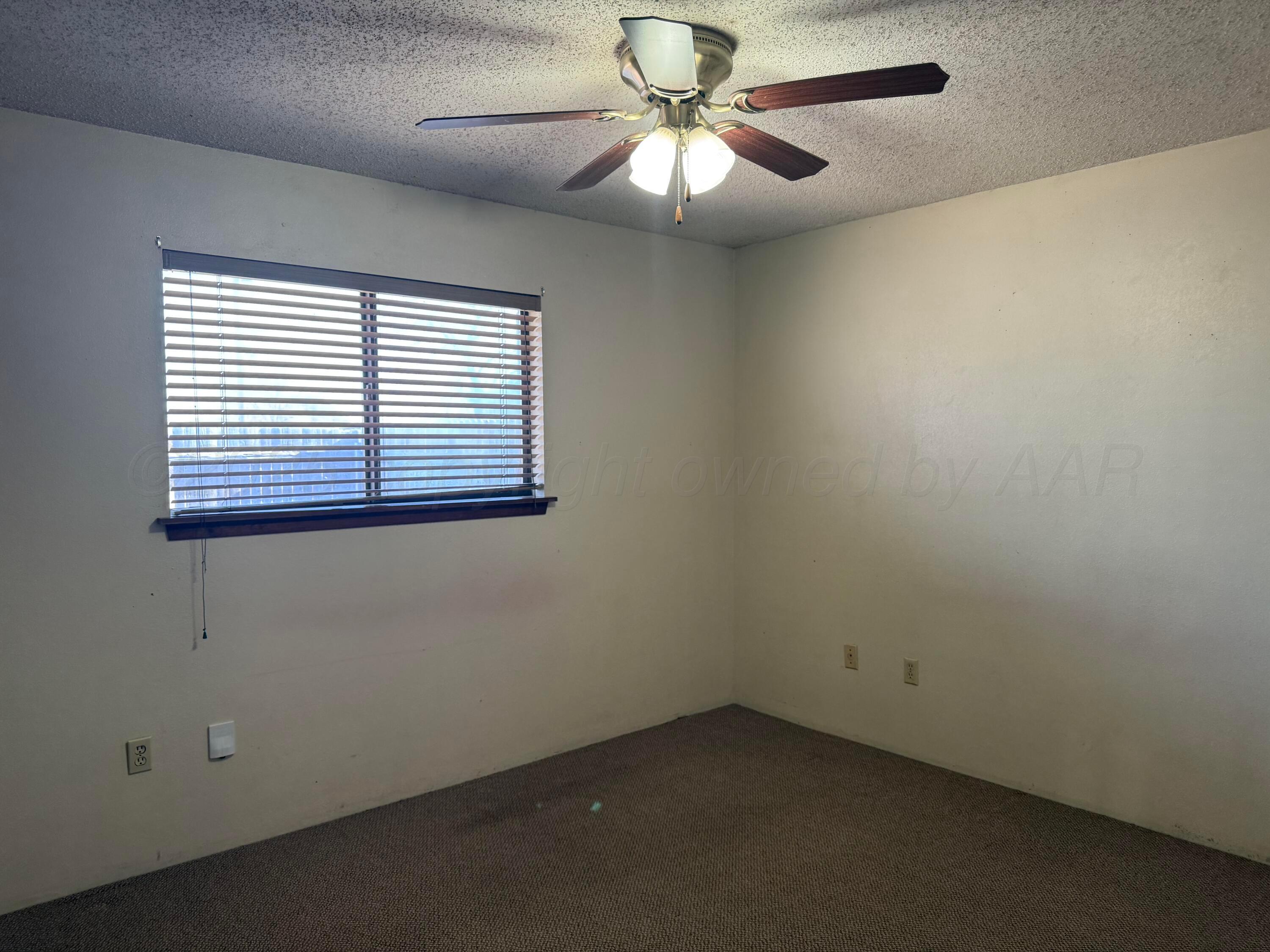 403 3rd Avenue Canyon, TX 79015 - Photo 5 of 8 an empty room with a window and a fan