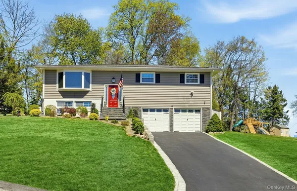 a front view of house with yard and green space