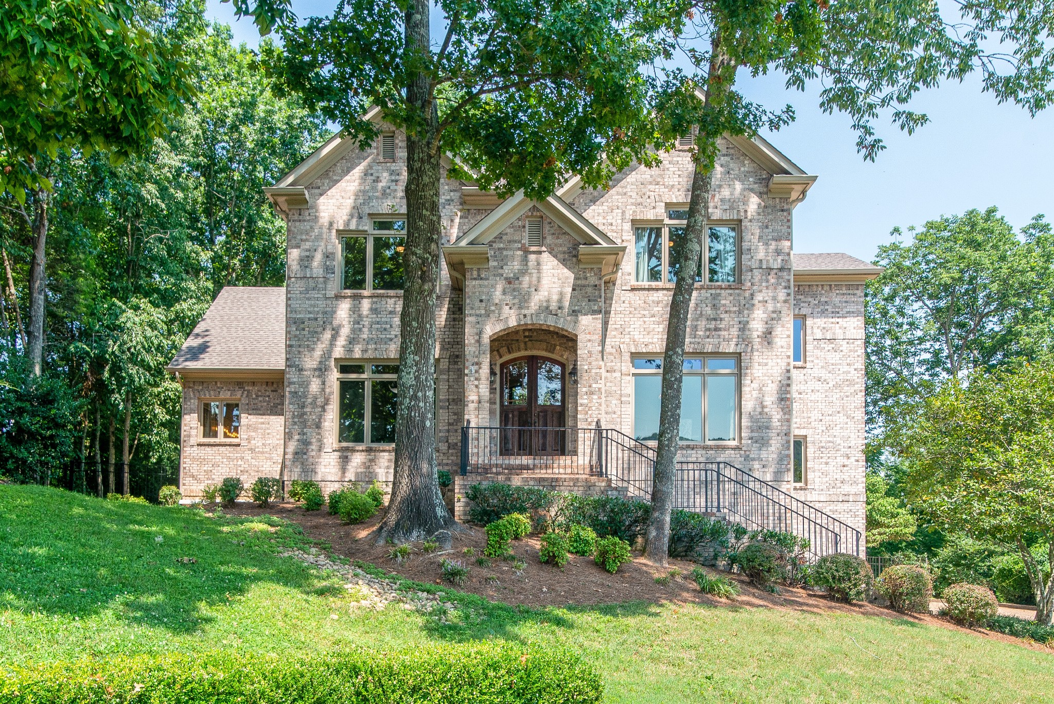 a front view of a house with garden