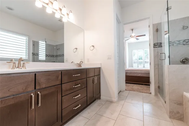 a bathroom with a sink a vanity and a large mirror