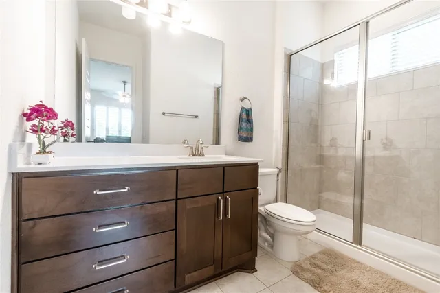 a bathroom with a sink vanity mirror and toilet
