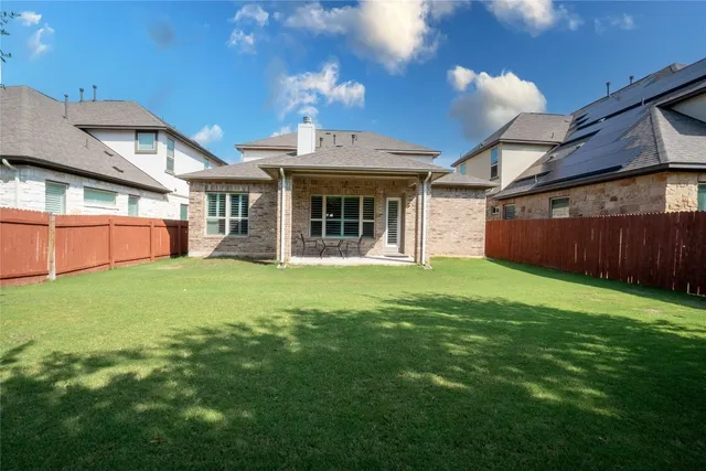a view of a house with backyard and porch