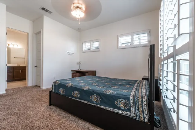 a bed sitting in a bedroom next to a window