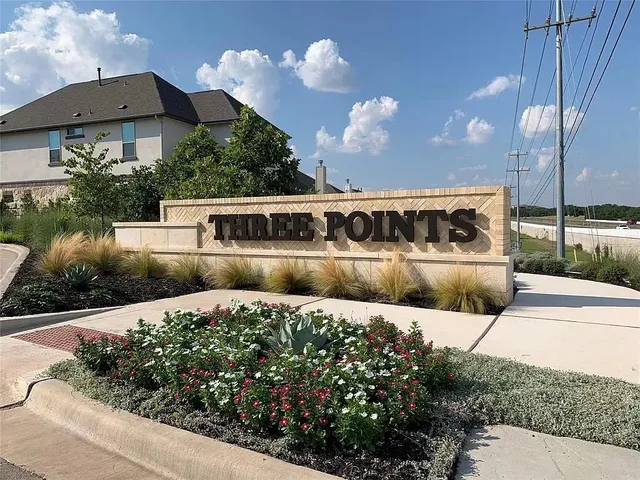 a view of a house with a yard and potted plants