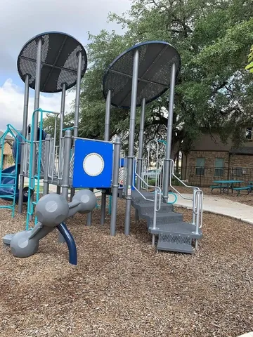 a view of a chairs and table in backyard