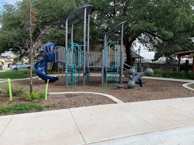 a view of a chair and table in backyard of the house