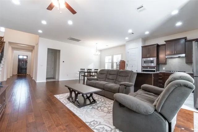 a living room with furniture and wooden floor