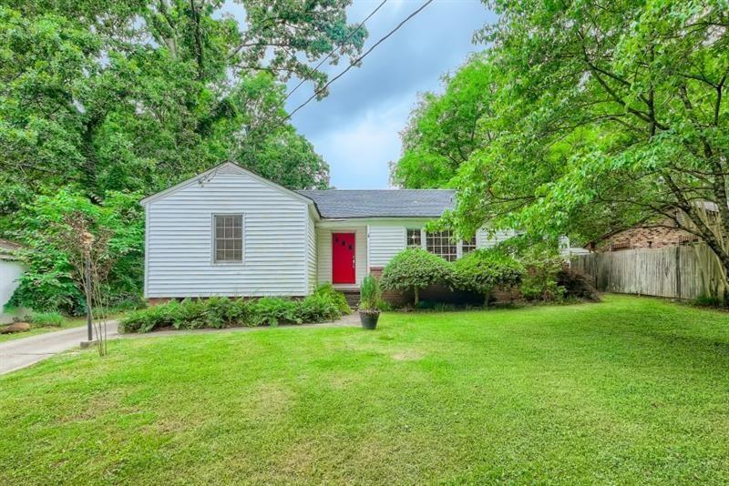 a view of a house with yard and a garden