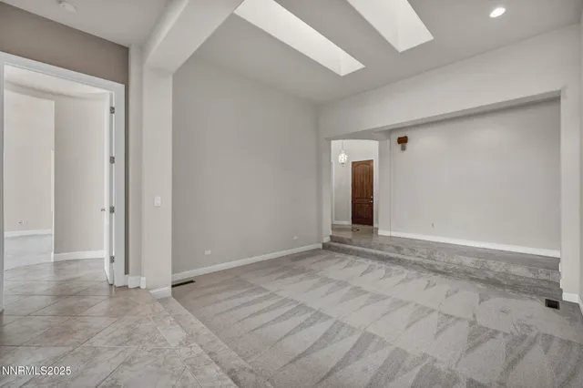 an empty room with a ceiling fan and a window