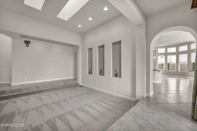 an empty room with windows and entrance