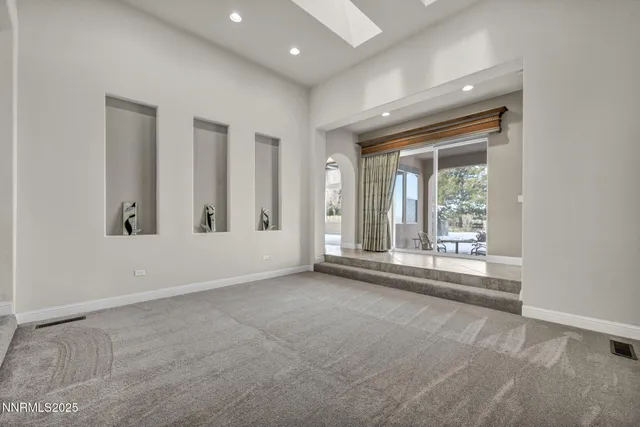 a bathroom with a granite countertop toilet sink and mirror