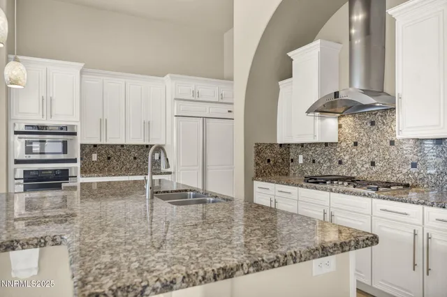 a bathroom with a granite countertop sink a mirror and a shower