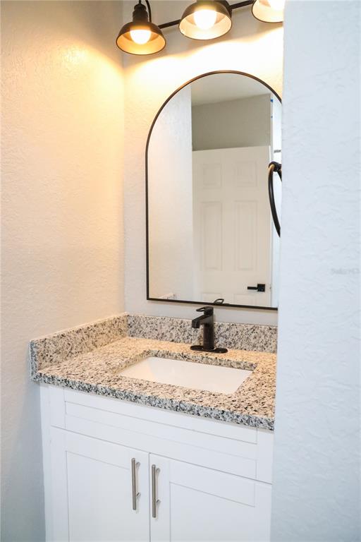 1850 Northwest 35th Street Ocala, FL 34475 - Photo 11 of 24 a bathroom with a granite countertop sink and a mirror