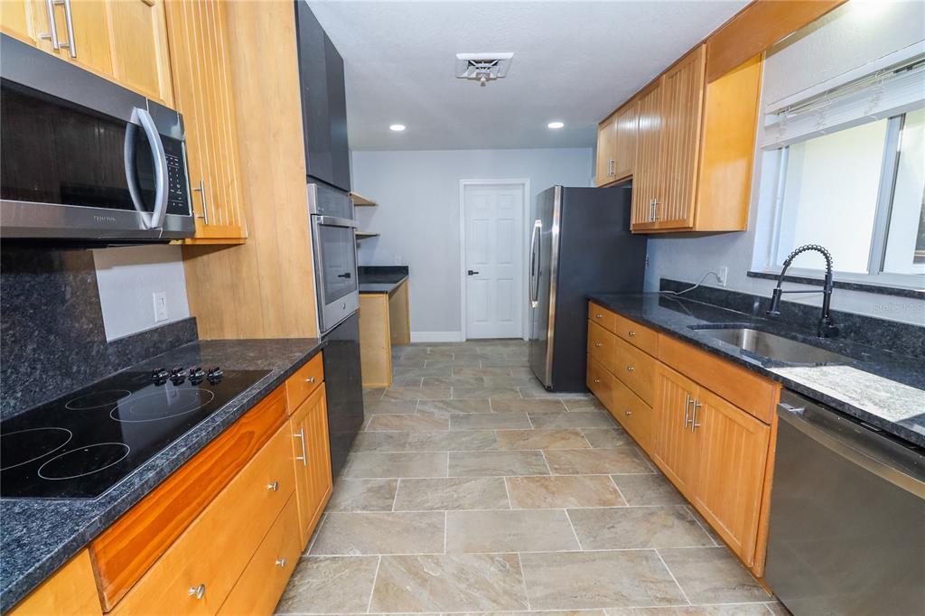 1850 Northwest 35th Street Ocala, FL 34475 - Photo 16 of 24 a kitchen with stainless steel appliances granite countertop a sink stove and refrigerator