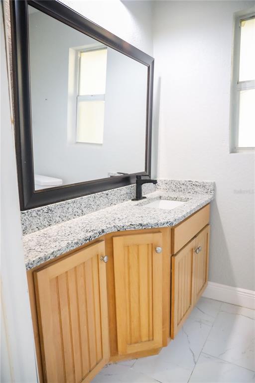 1850 Northwest 35th Street Ocala, FL 34475 - Photo 17 of 24 a bathroom with a granite countertop sink and a mirror