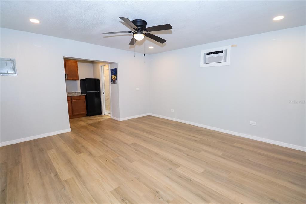 1850 Northwest 35th Street Ocala, FL 34475 - Photo 20 of 24 a view of a livingroom with a ceiling fan wooden floor and a ceiling fan
