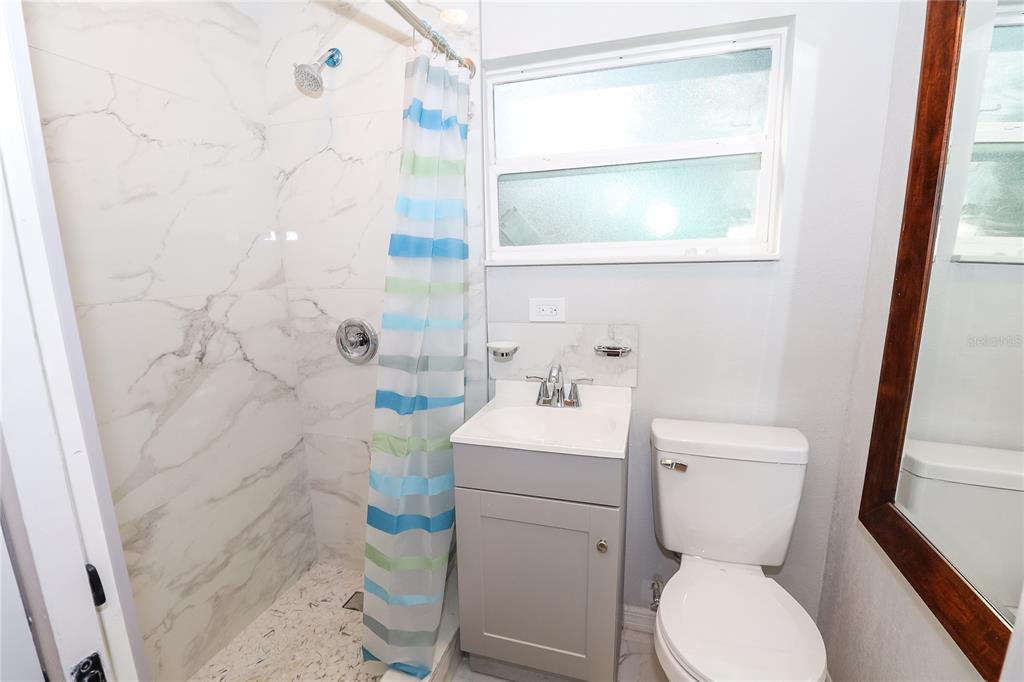 1850 Northwest 35th Street Ocala, FL 34475 - Photo 21 of 24 a bathroom with a toilet sink and a shower