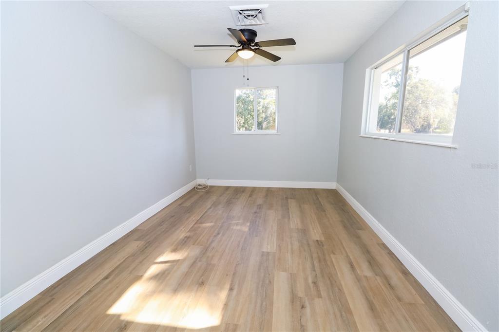 1850 Northwest 35th Street Ocala, FL 34475 - Photo 6 of 24 wooden floor in an empty room with a window